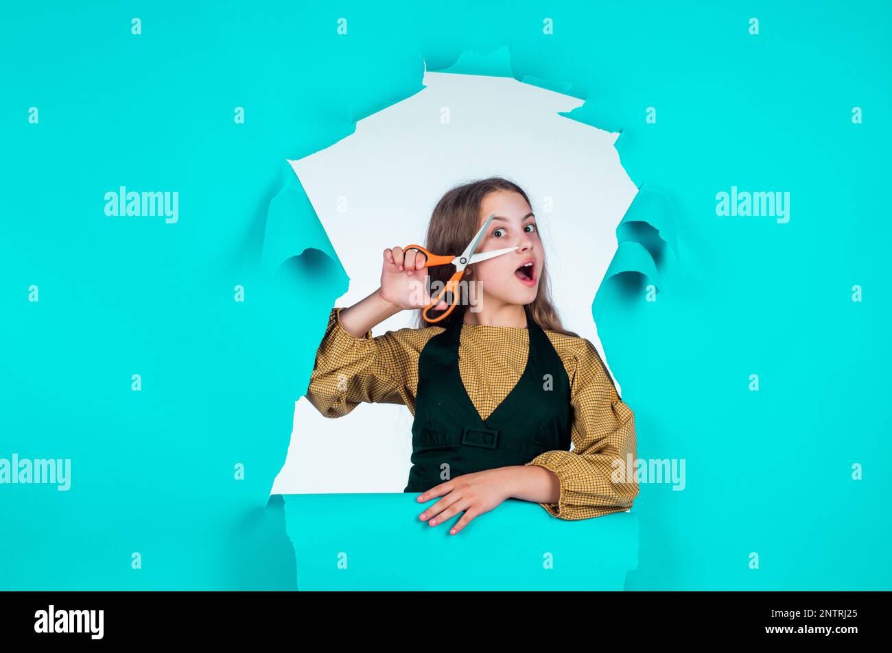 kid use scissors tool in beauty salon. fashion of hairdo. child cut