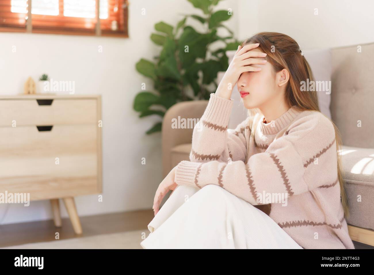 Rest time concept, Women is sitting on the floor and touch aching ...