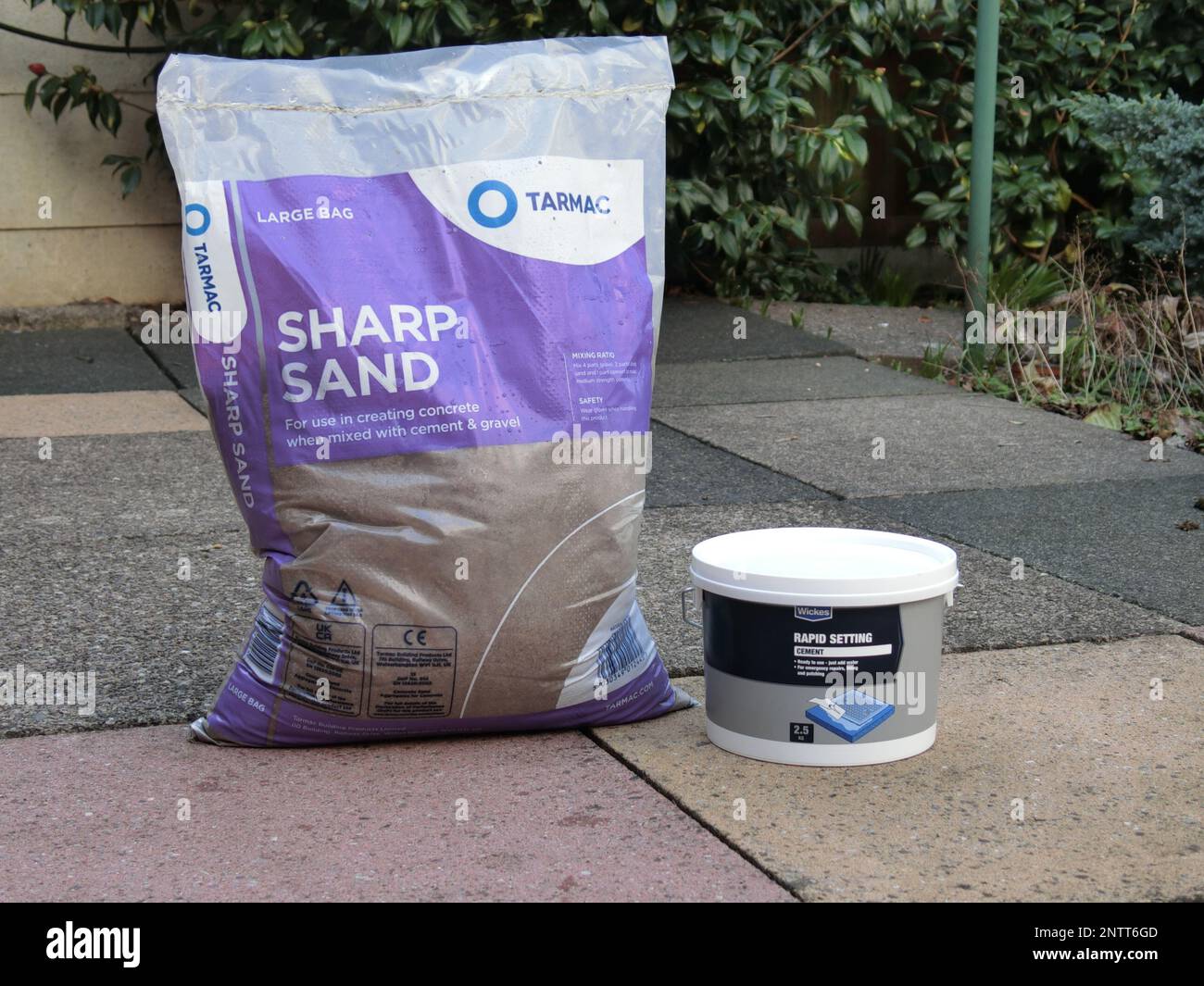Bag of Sharp Sand & Quick Drying Cement on Paving Slabs, UK Stock Photo