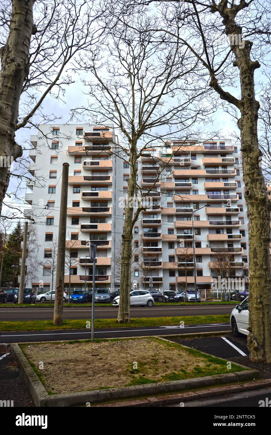 Saint-Etienne, France - January 27th 2020 : Focus on cyan and orange modern buildings with a park, known as 'HLM' in France. HLM are dwellings moderat Stock Photo