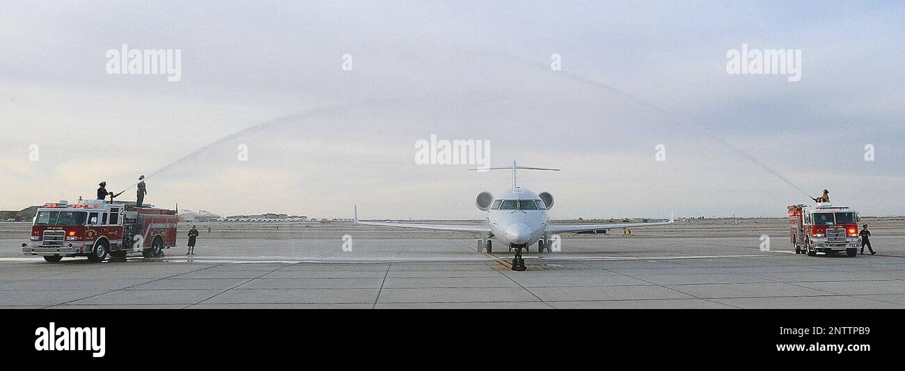 Yuma Fire Department fire trucks conduct a "water salute" with American