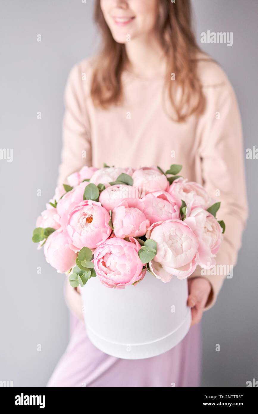 Round box with Bouquet of Pink peonies in a women hand. Beautiful peony ...