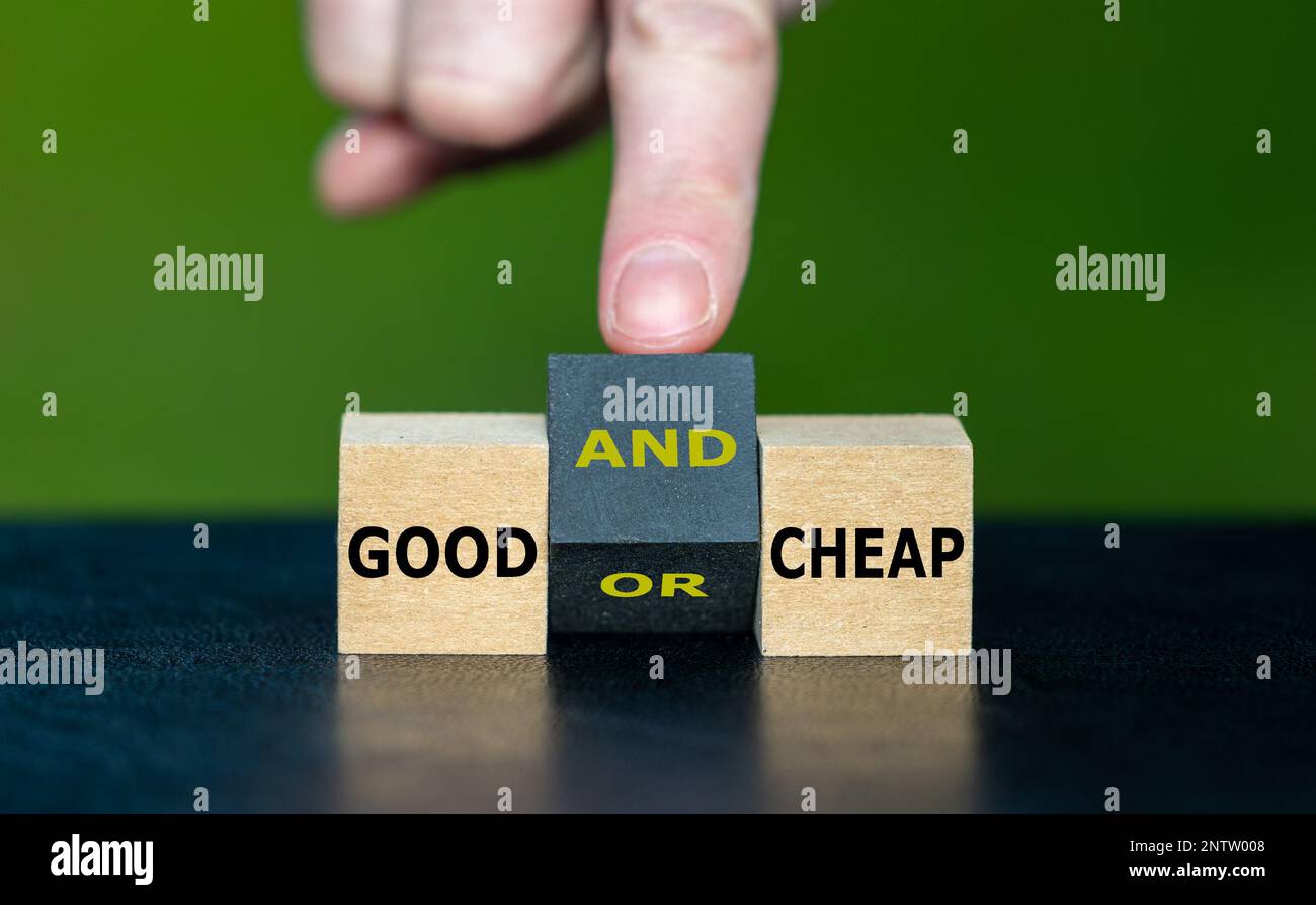 Hand turns wooden cube and changes the expression 'good or cheap' to 'good and cheap'. Stock Photo