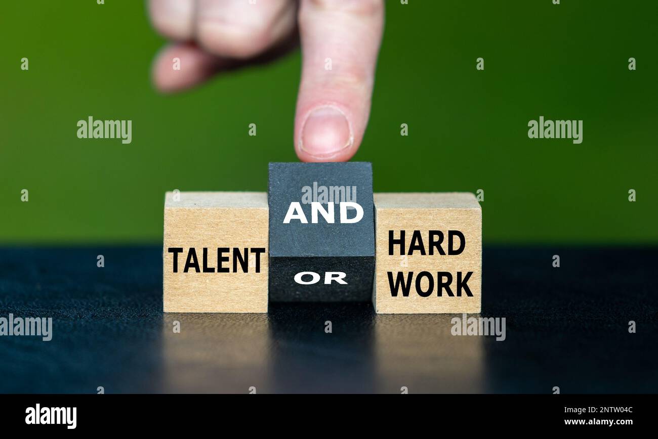 Hand turns cube and changes the expression 'talent or hard work' to 'talent and hard work'. Stock Photo