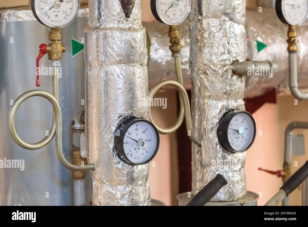Plumbing pipes with pressure gauges in the basement of a house Stock