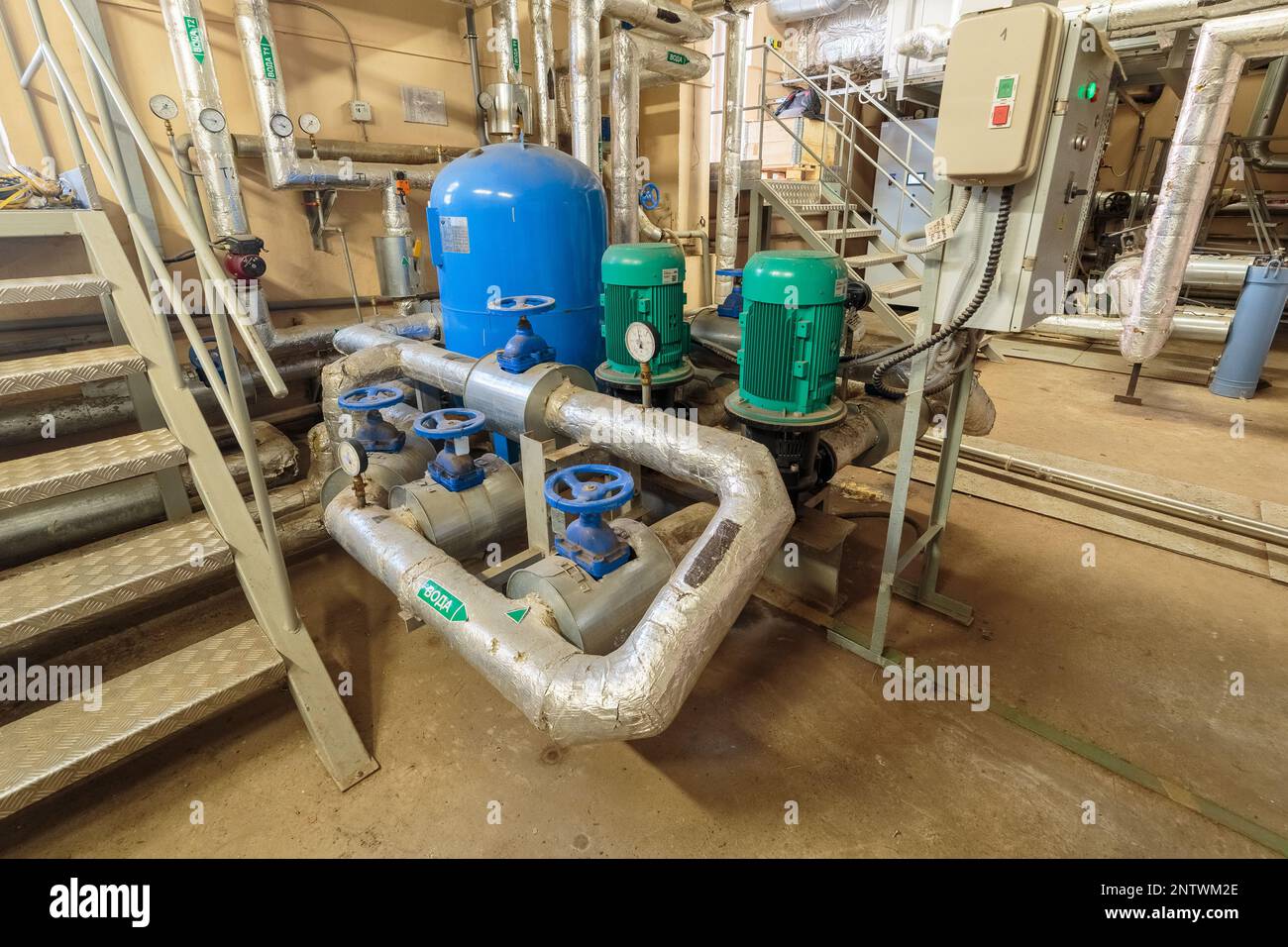 Electric pump with manometer. Pumping station in the basement with two