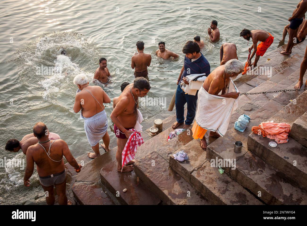 Pilgrims praying and bathing, in the ghats of Ganges river, Varanasi ...
