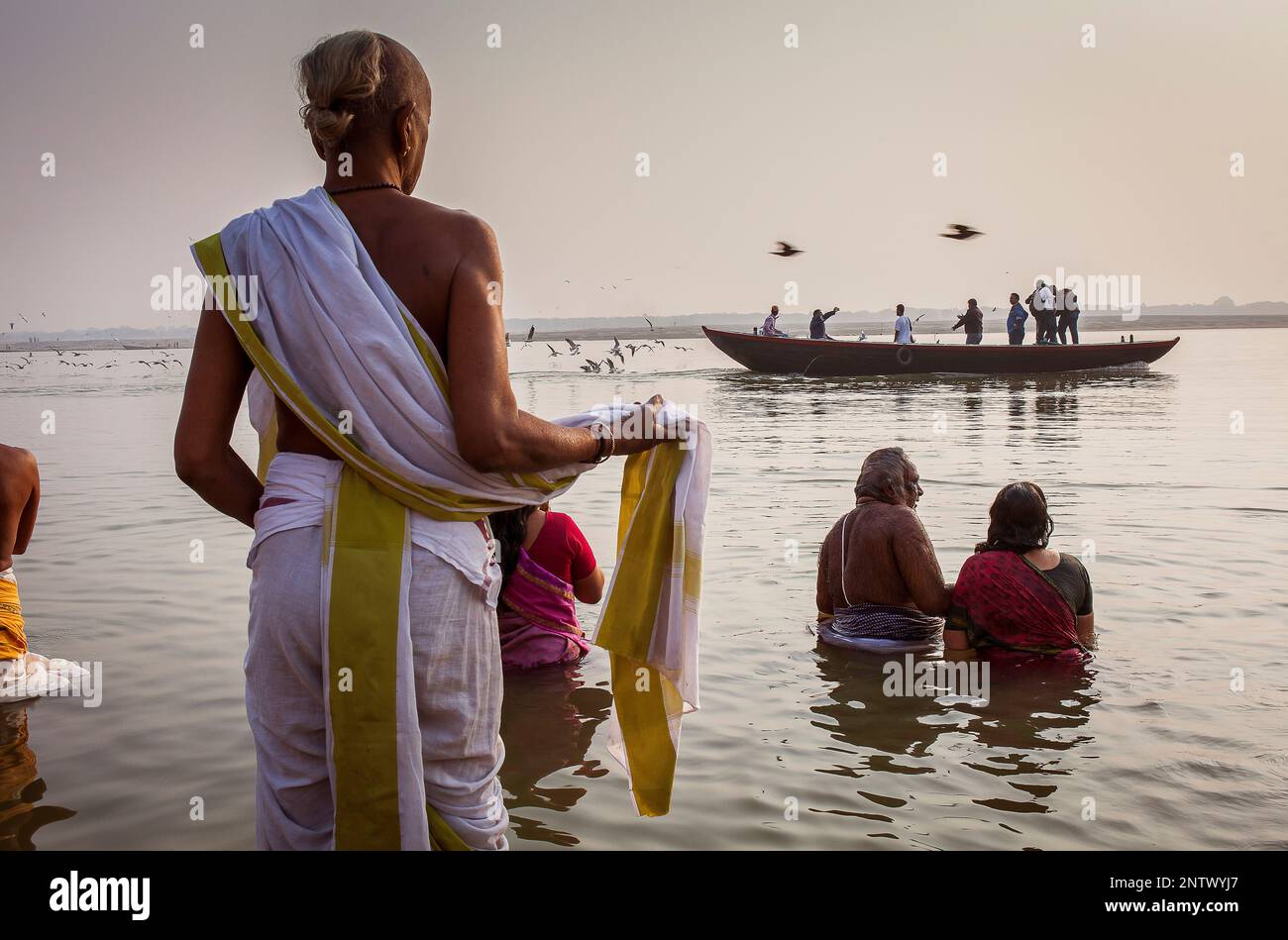 Pilgrims praying and bathing, in the ghats of Ganges river, Varanasi ...