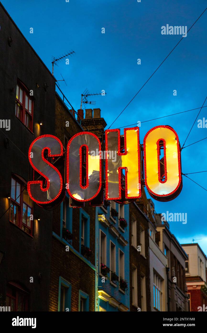 Colourful soho neon sign hanging in the Carnaby Street area during the festive period, London, England, UK Stock Photo
