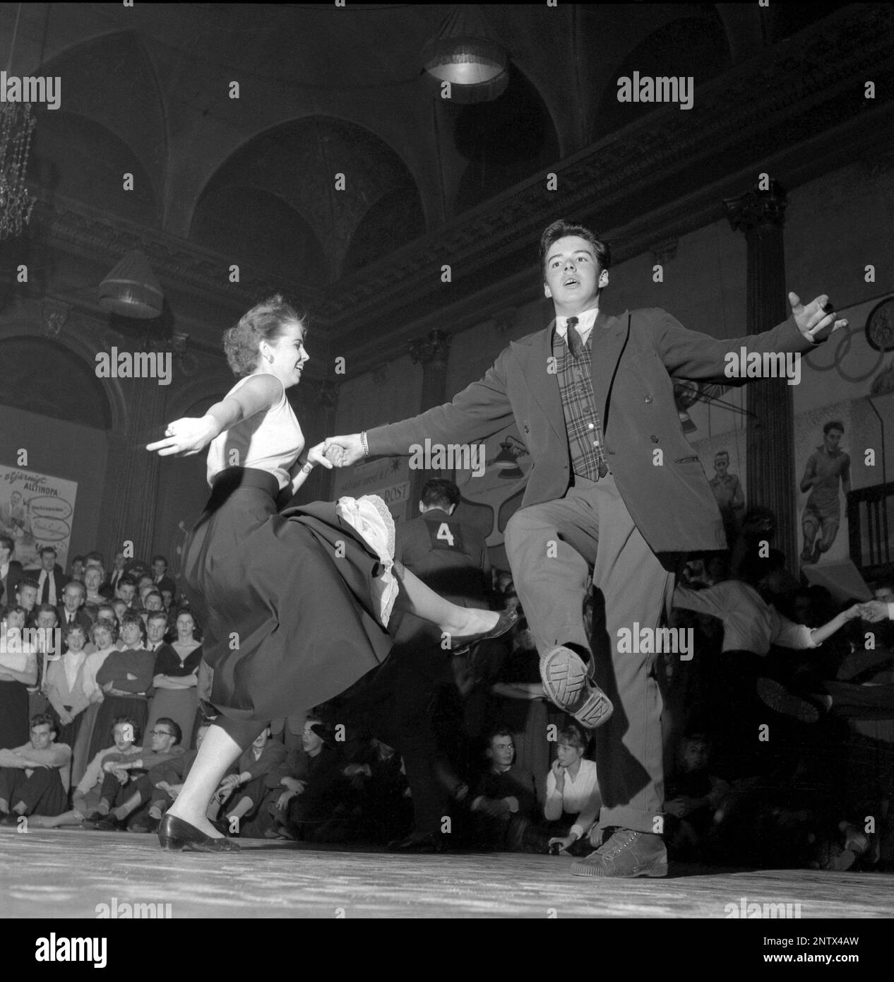 Dancing in the 1950s. A young couple is pictured on the dance floor at Nalen Stockholm, dancing the Sluefoot. Dancing the Sluefootcan be done to most any jazz beat, som of the steps in this dance are referred to as Slueing. The dance features considerable leg jolting, arm jabbing and shuffling.  A dance that was made somewhat popular by american dancers Leslie Caron and Fred Astaire in the 1955 film Daddy long legs. Sweden 1957 Conard ref 3122 Stock Photo