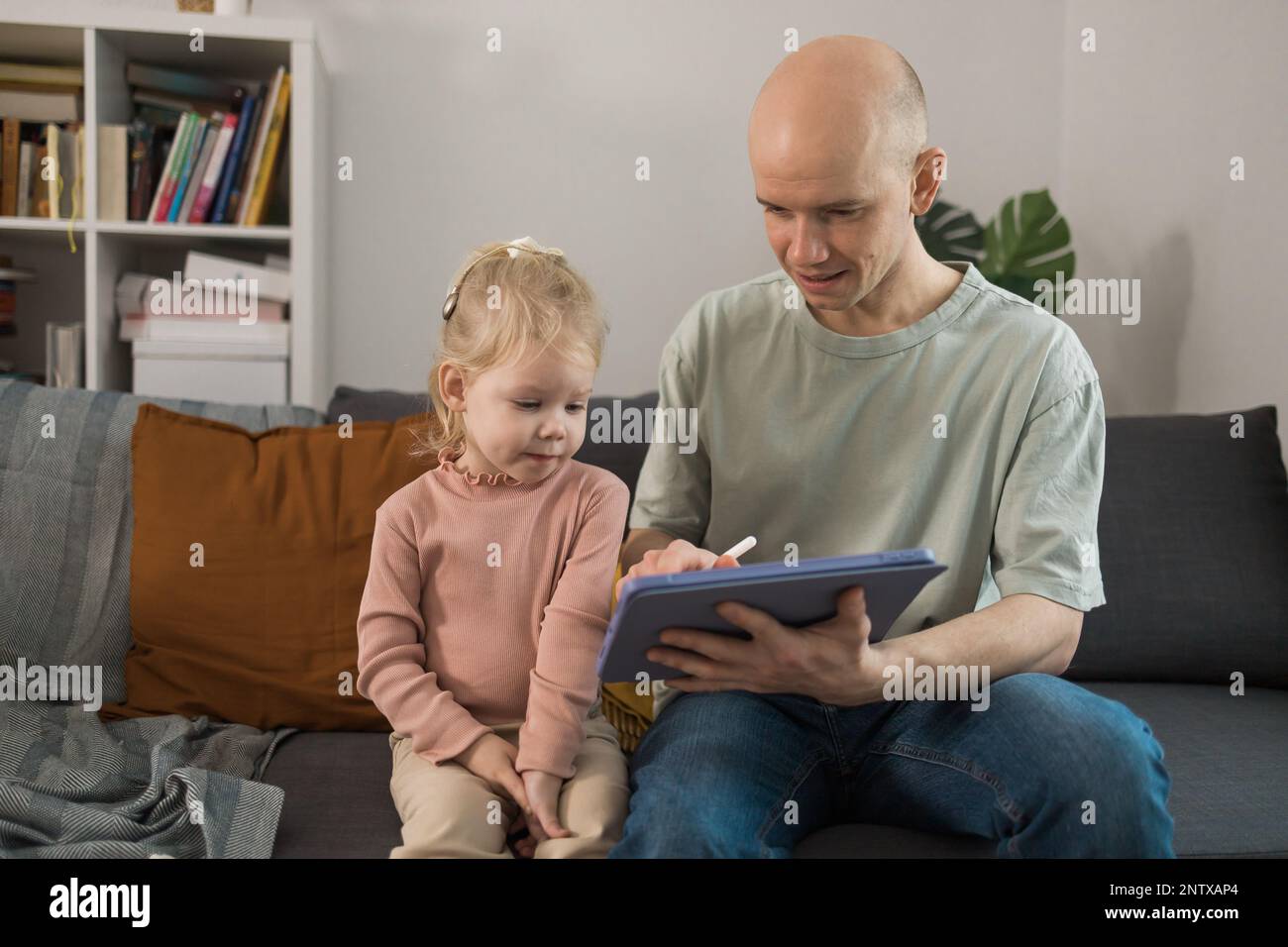 People with cochlear implant system. Kid study to hear with her father ...