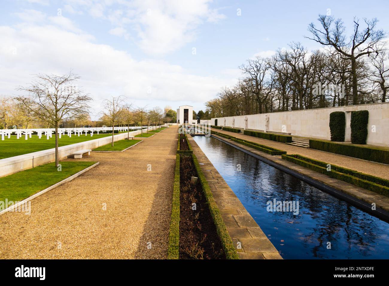 Looking towards the Chapel with the Walls of the Missing and water. Cambridge American Cemetery and Memorial, Madingley, Cambridgeshire, England Stock Photo