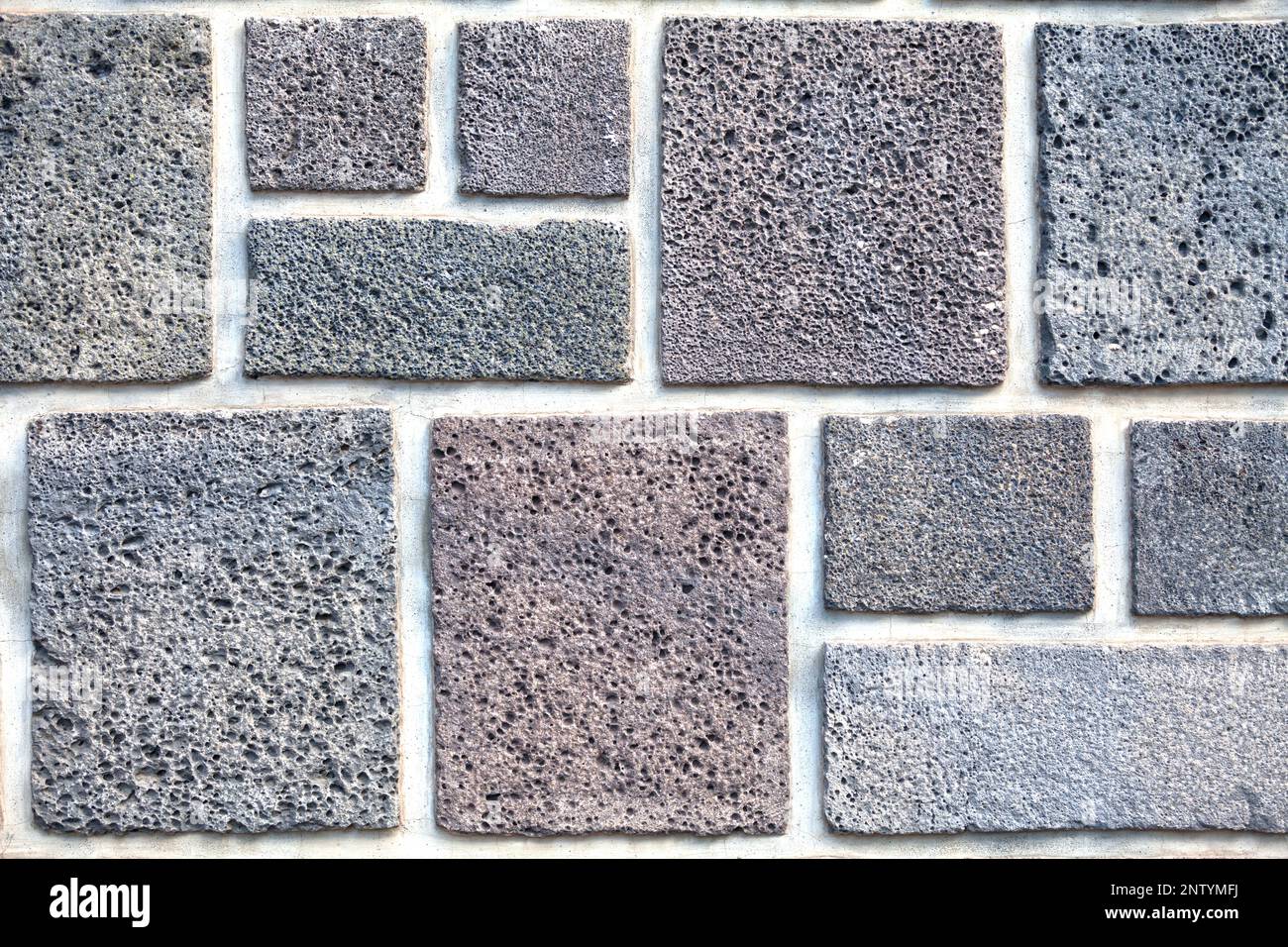 Close up on a square shaped volcanic stone wall Stock Photo - Alamy