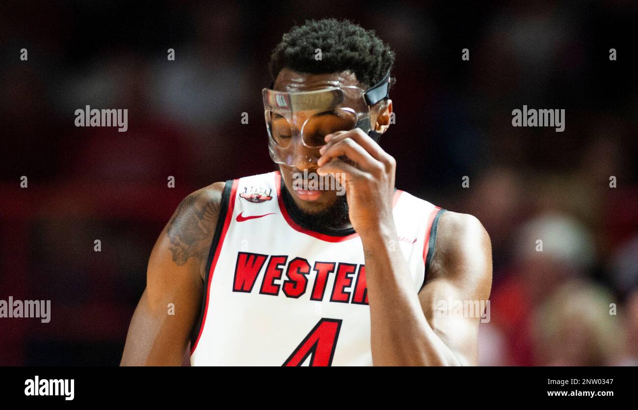 Western Kentucky Hilltoppers guard Josh Anderson (4) adjusts his mask ...