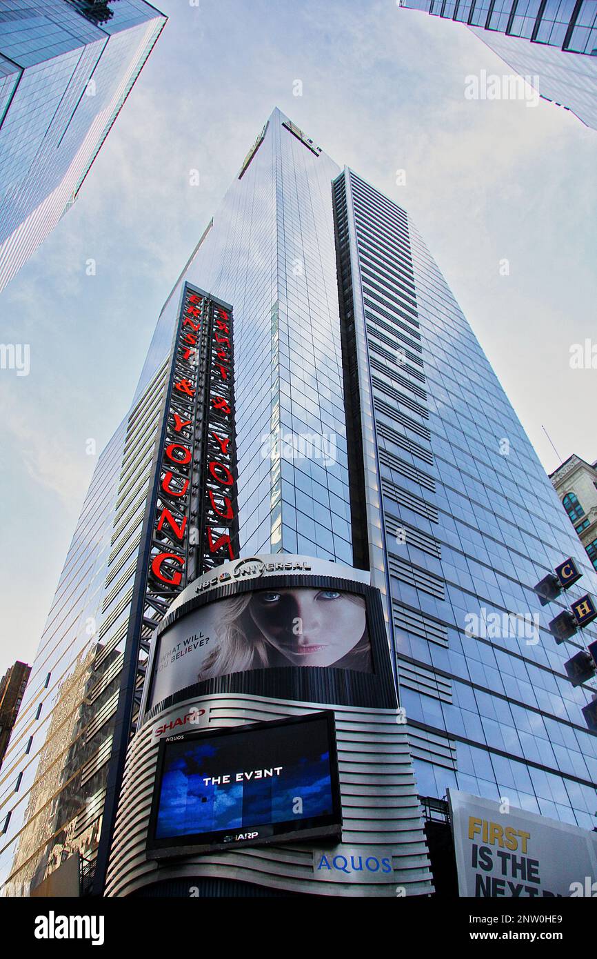 A glass new york building steeply photographed from below on a bright