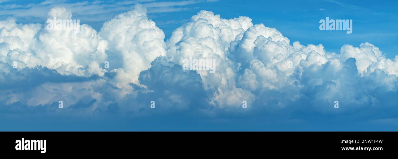 Panoramic image of cumulus clouds at the sky in summer afternoon Stock Photo