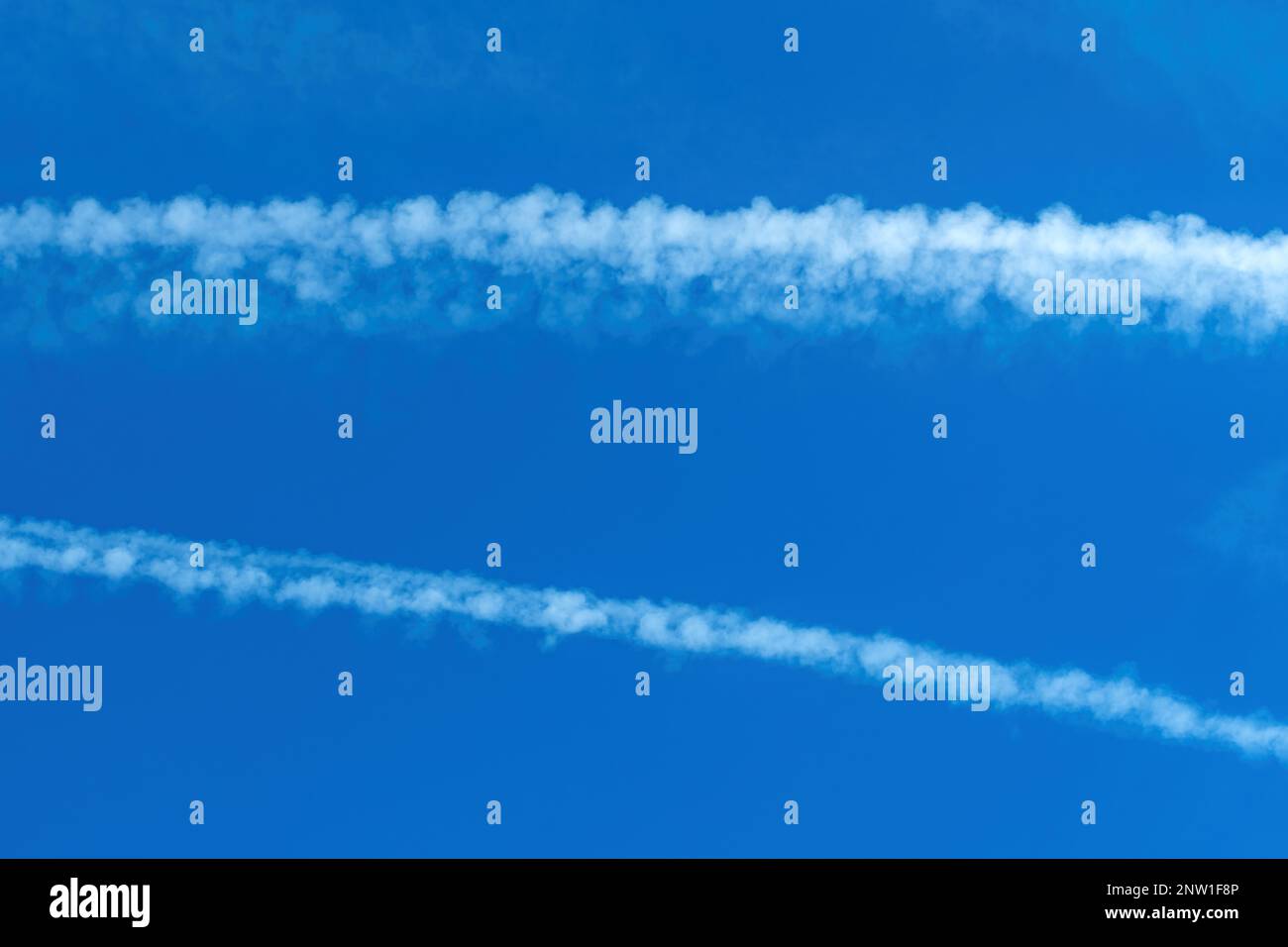 Airplane contrail across the blue sky, copy space included Stock Photo