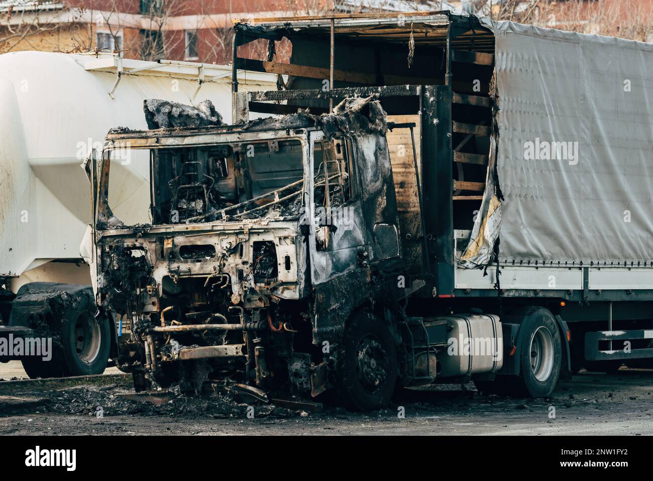 Semi truck engulfed by fire flames after traffic accident is burned and damaged, selective focus Stock Photo
