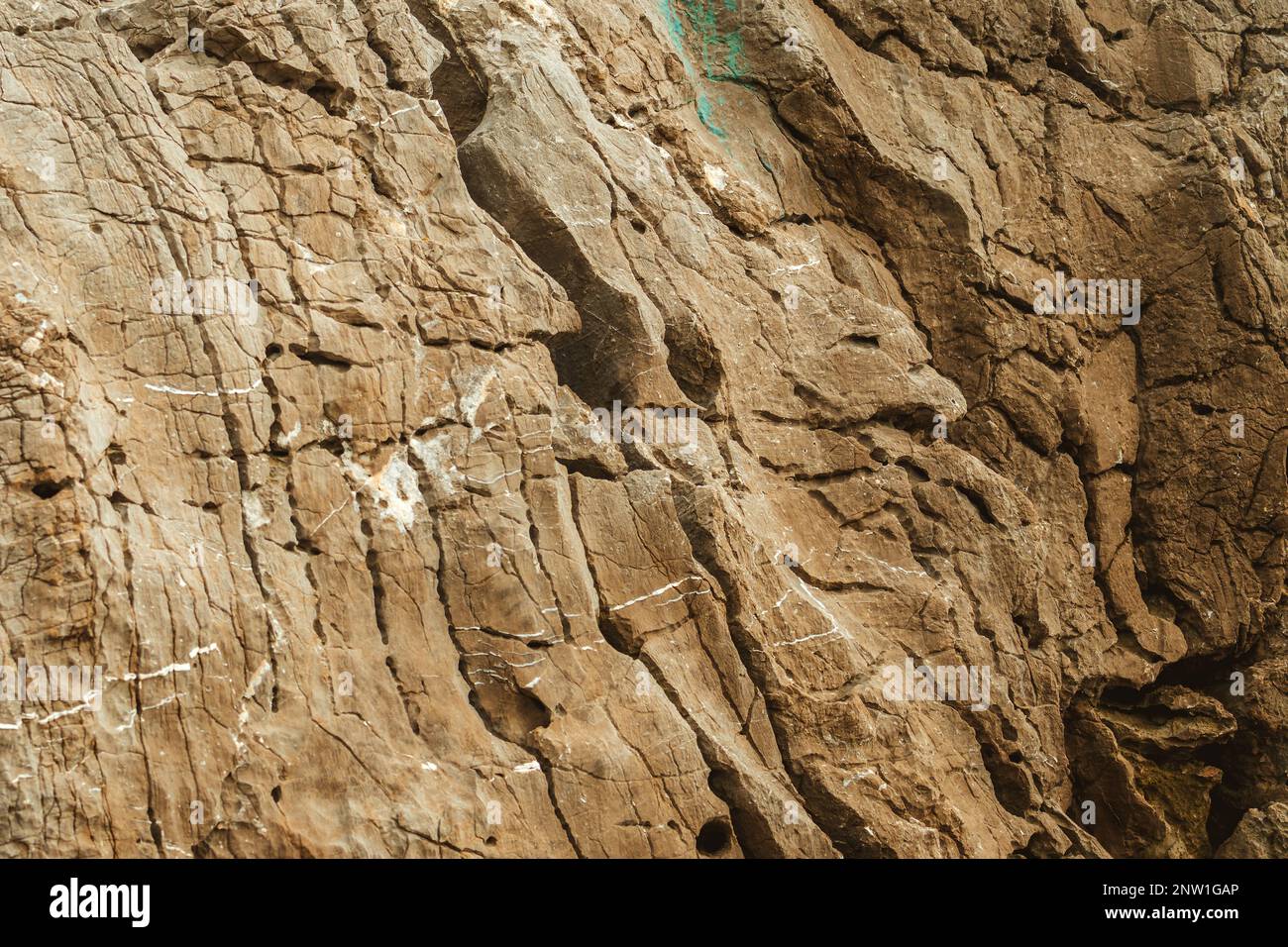 Texture of rough brown rock cliff as natural background Stock Photo