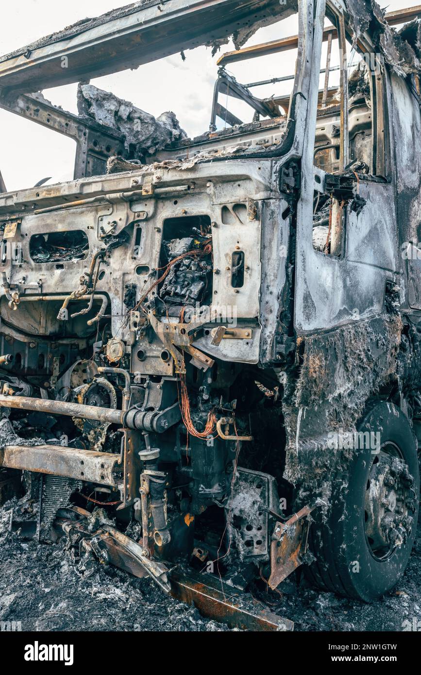 Semi truck engulfed by fire flames after traffic accident is burned and damaged, selective focus Stock Photo