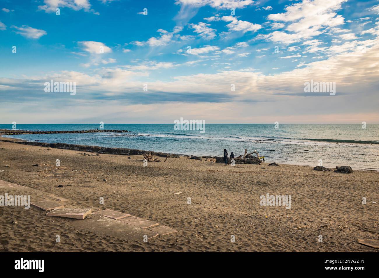 February 12, 2023 - Ostia, Rome, Italy. The sea of Ostia, on the Roman coast, on a winter Sunday. People enjoy the public holiday by walking on the be Stock Photo