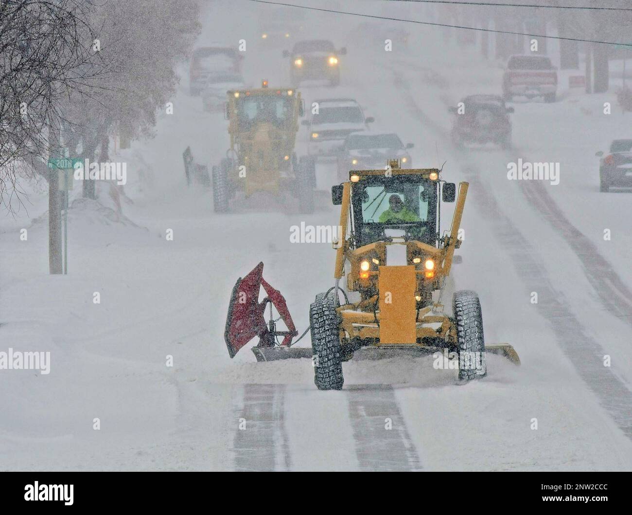 Motor graders plow Rosser Avenue as snow falls, Friday, Jan. 18, 2019