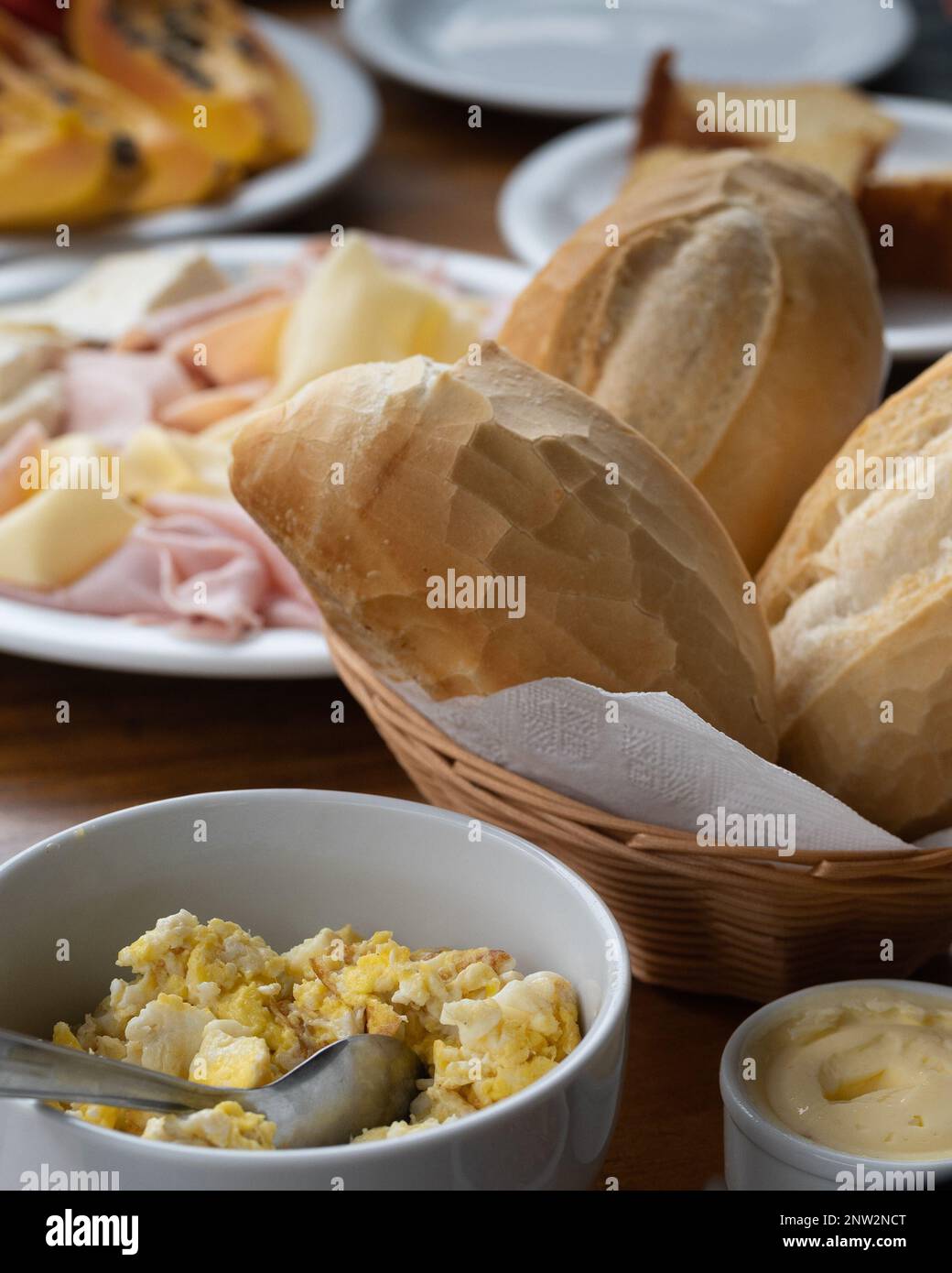 Brazilian breakfast concept with Minas cheese (queijo minas), ham and Prato cheese (queijo Prato) served with corn bread, french bread, under natural Stock Photo