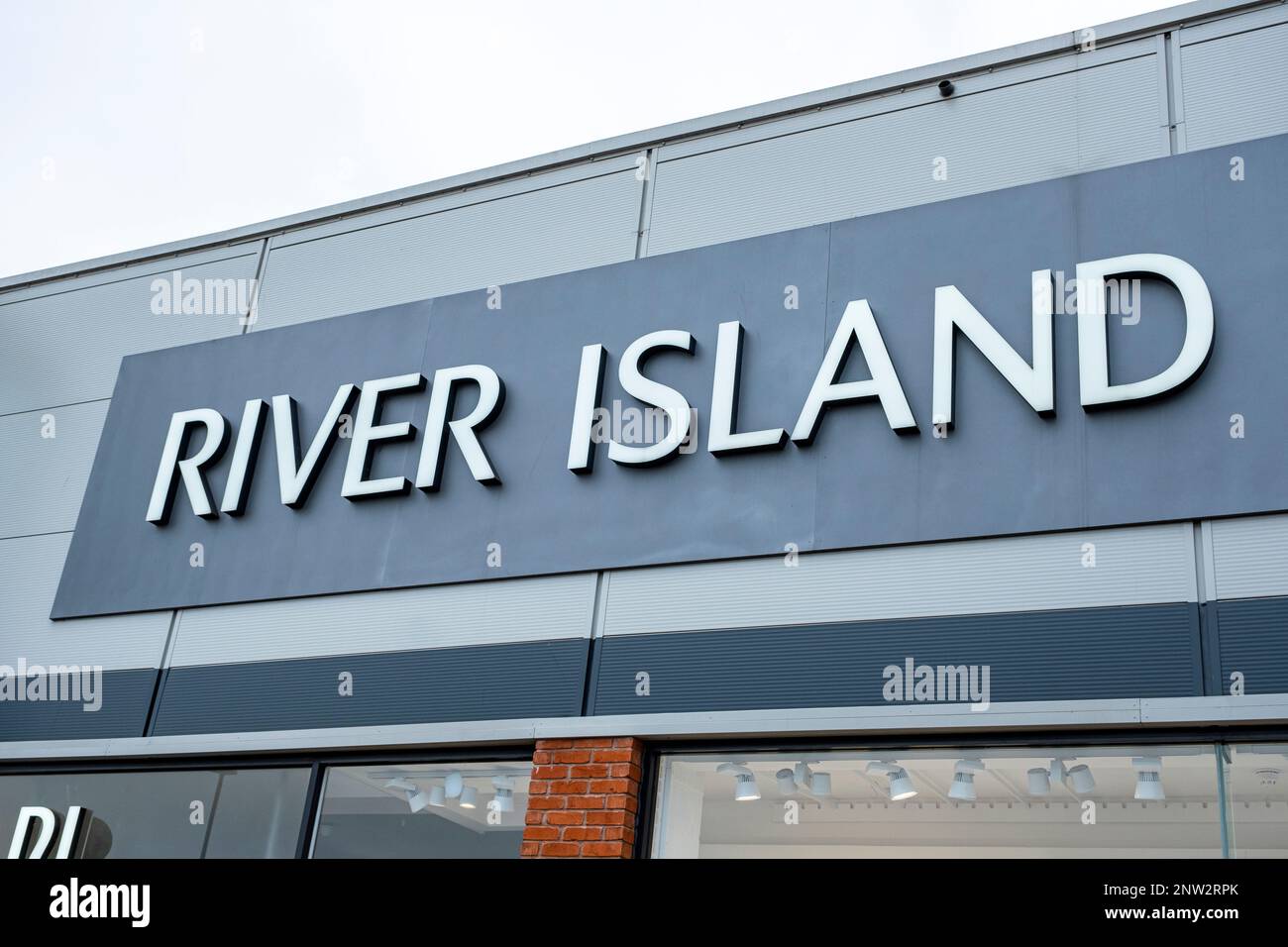 Close up of River Island Fashion shop sign on outside wall UK Stock Photo