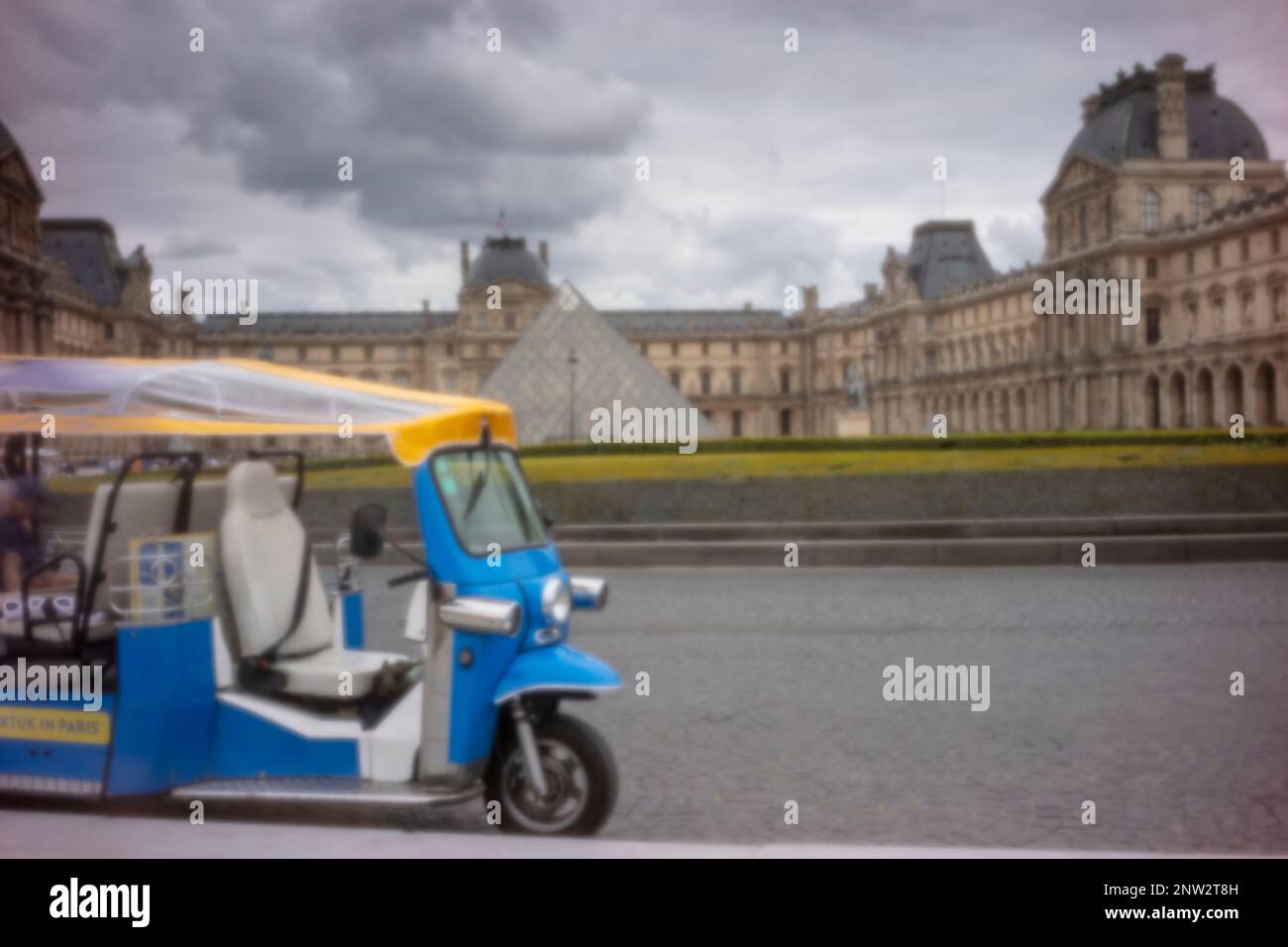 New, Age-defying, eye-catching, stand-out, high resolution, pinhole image ofTut-Tut tourist transport in front of the Louvre Pyramid and Museum, Paris Stock Photo