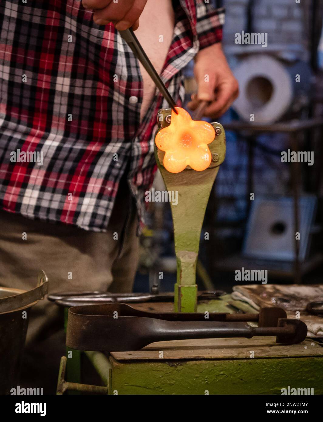 A glassworks worker shows traditional methods of making decorative