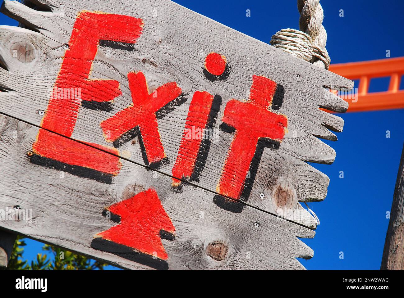 A painted sign points to the exit Stock Photo