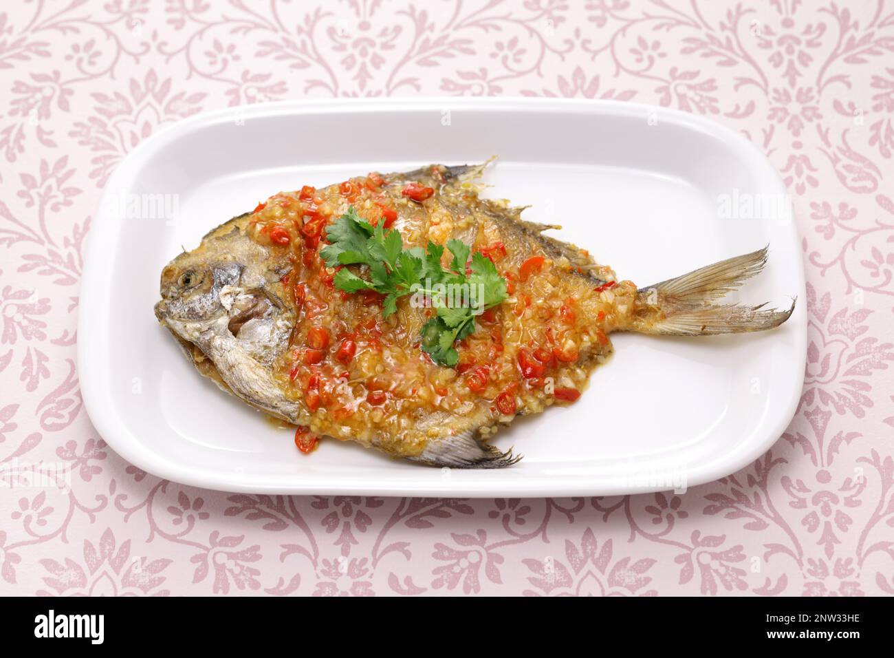 fried pomfret fish with chili sauce, Thai cuisine Stock Photo