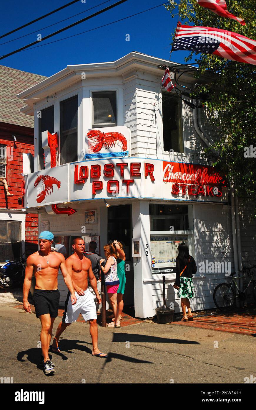 Two men enjoy the summer weather strolling through Provincetown, on