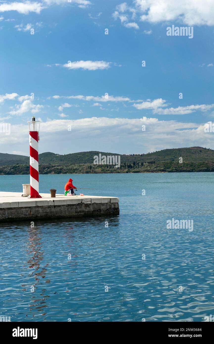 A fisherman in Porto Montenegro, Montenegro Stock Photo