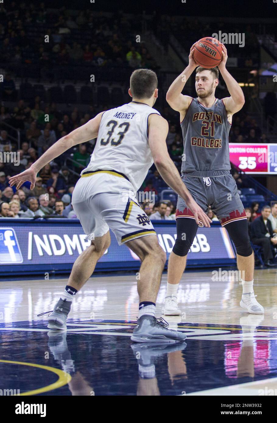January 12, 2019: Boston College forward Nik Popovic (21) passes the ball  as Notre Dame forward John Mooney (33) defends during NCAA Basketball game  action between the Boston College Eagles and the