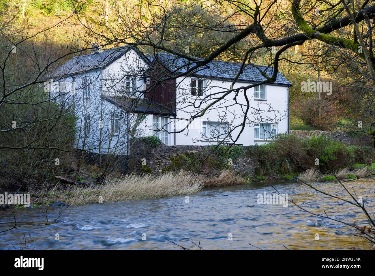 A cottage on the bank of the River Barle near Dulverton in the Exmoor National Park, Somerset, England. Stock Photo