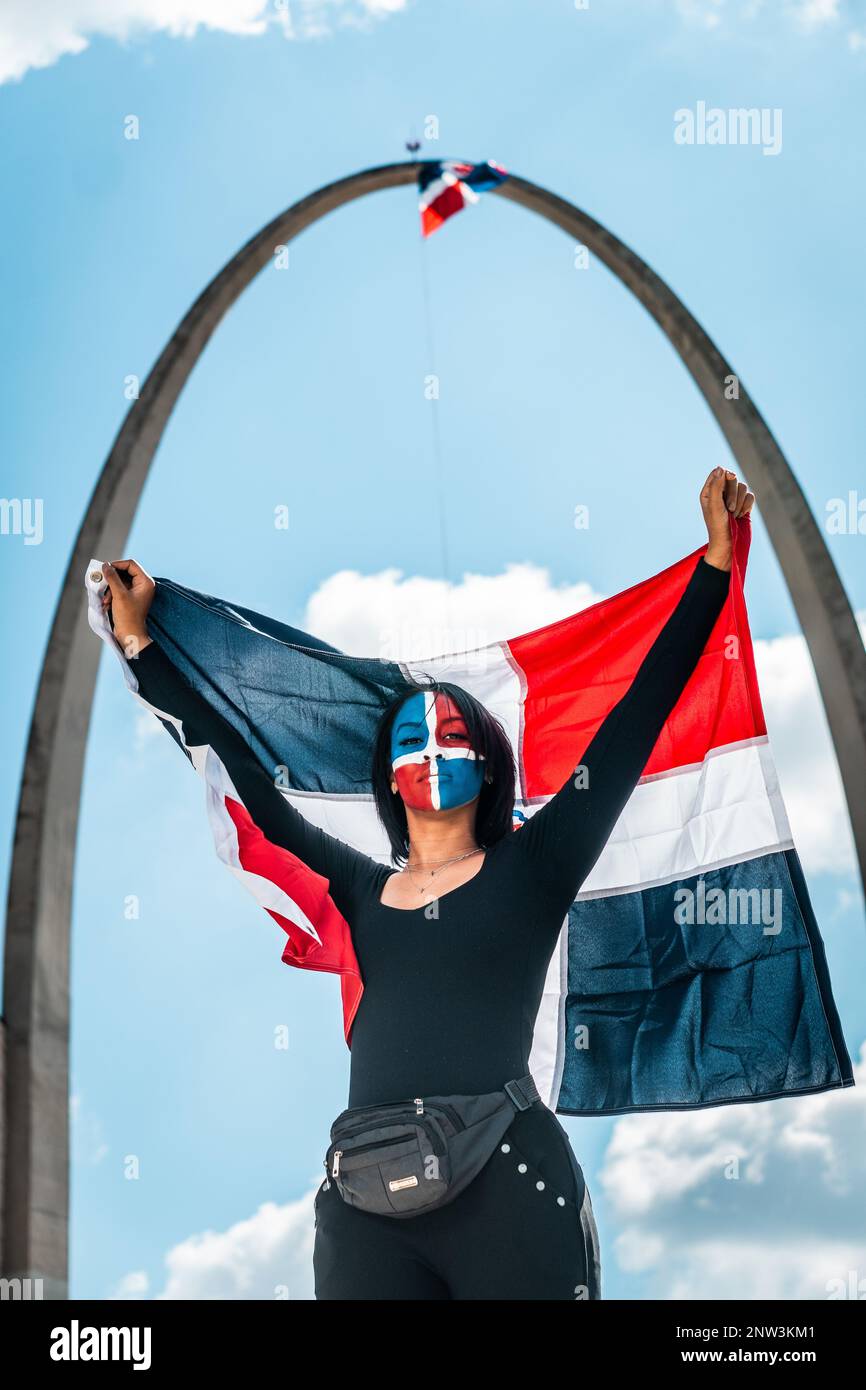 Dominican woman in the center of flag square in Santo Domingo. Stock Photo