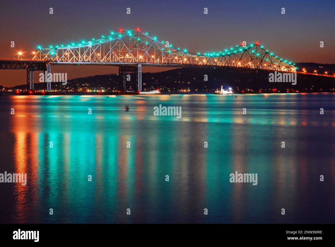 The lights of the former Tappan Zee Bridge reflect in the calm water of