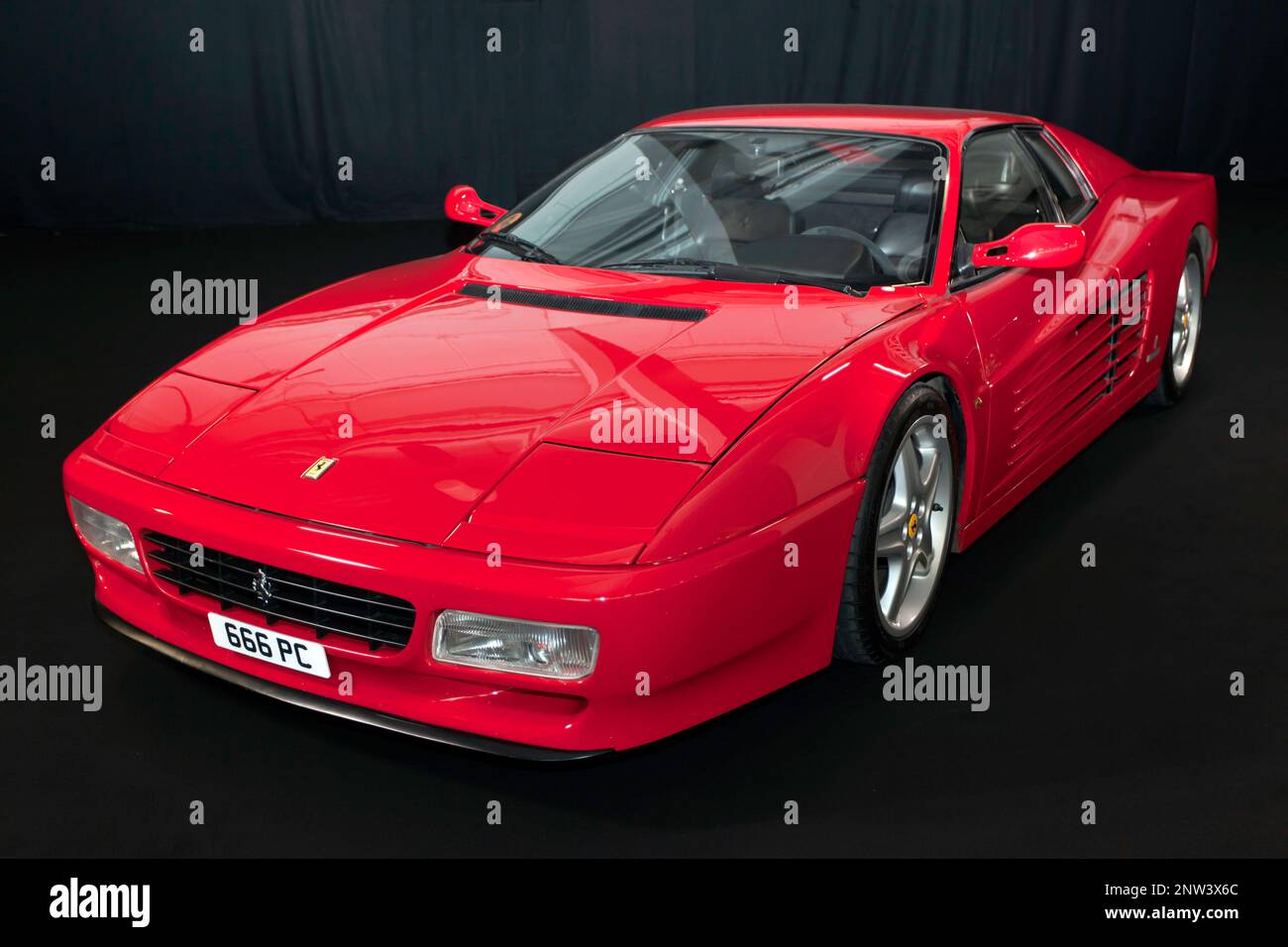 Studio Shot of a Red, Ferrari Testarossa, on the art of cars stand,  at the 2023 London Classic Car Show Stock Photo