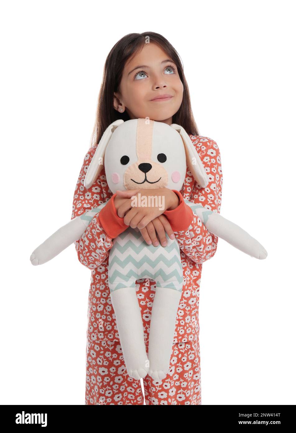 Cute girl wearing pajamas with toy on white background Stock Photo - Alamy