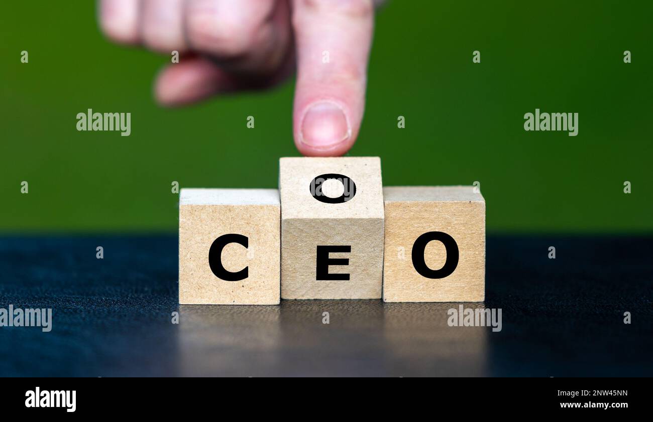 Hand turns cube and changes the abbreviation COO (chief operating officer) to  CEO (chief executive officer). Stock Photo