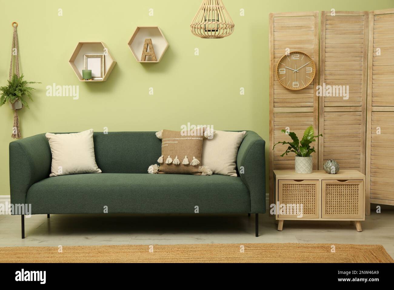 Living room with comfortable green sofa. Interior design Stock Photo