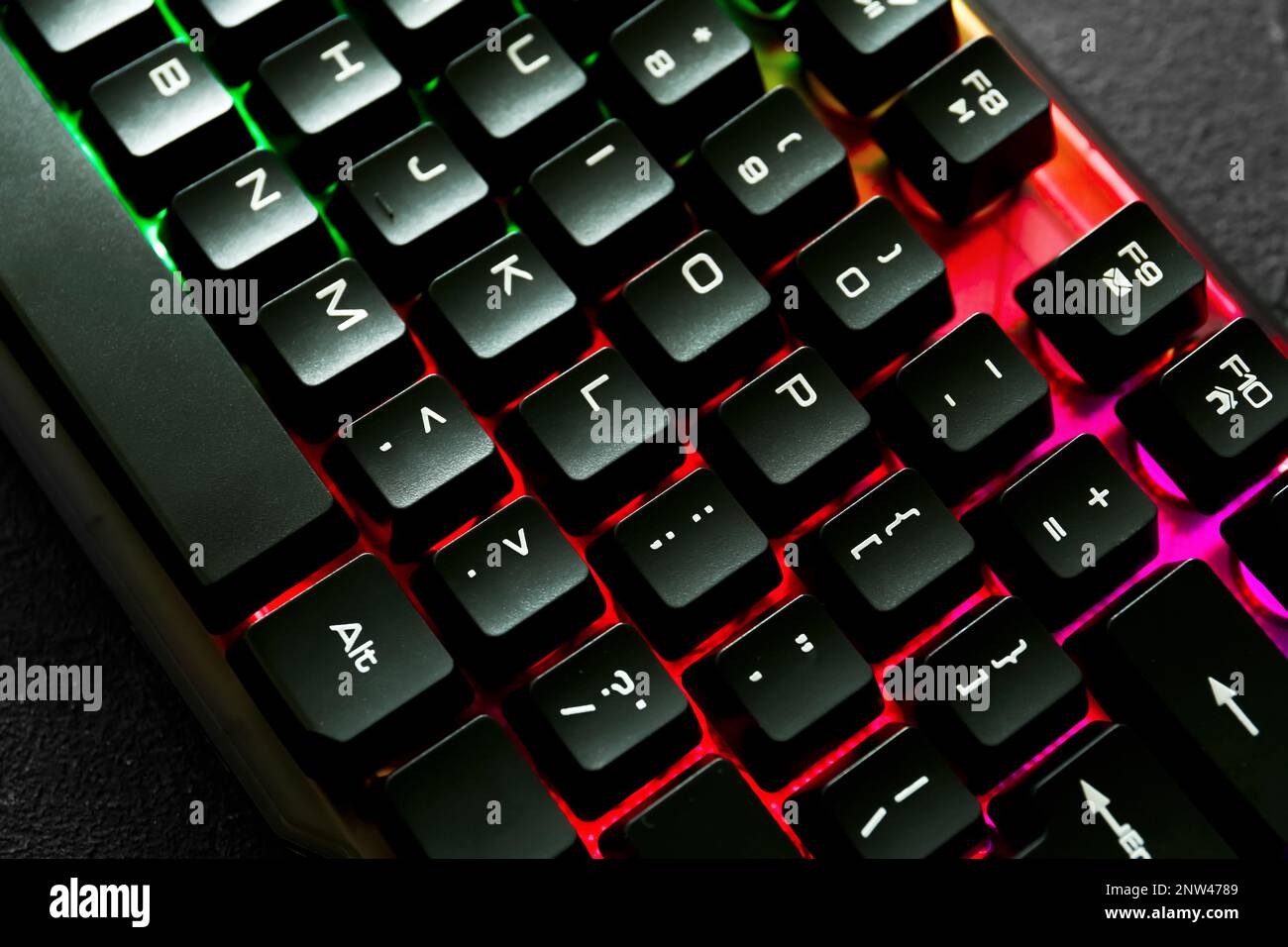 Modern keyboard with RGB lighting on grey table, closeup Stock Photo