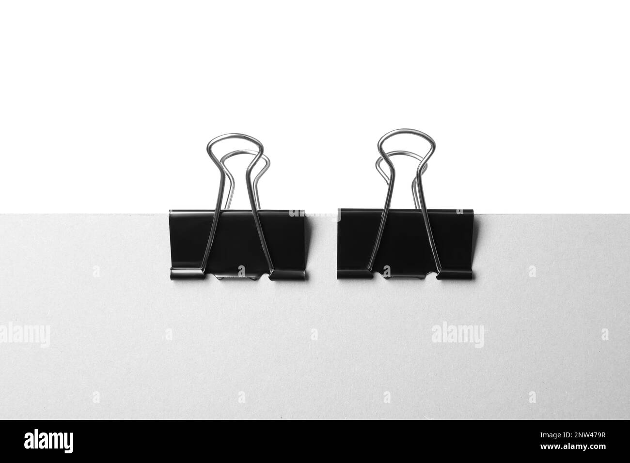 Paper with black binder clips isolated on white Stock Photo Alamy