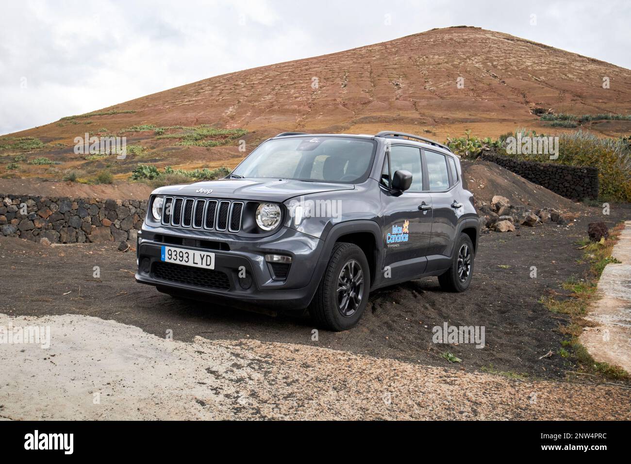 jeep renegade hire car parked off road beneath volcano in Lanzarote, Canary Islands, Spain Stock Photo