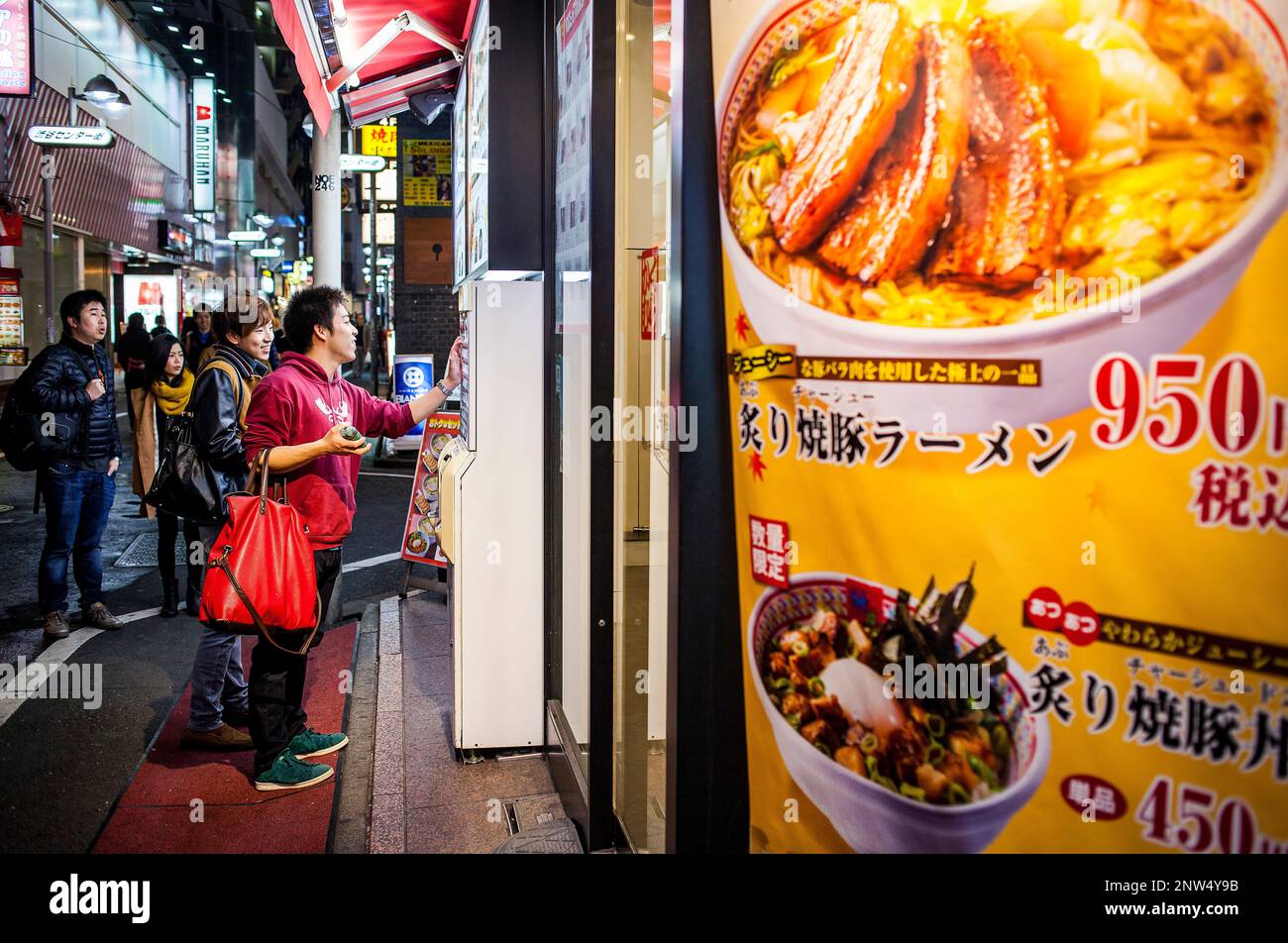 Choosing meal from vending machine in a restaurant, Main street of