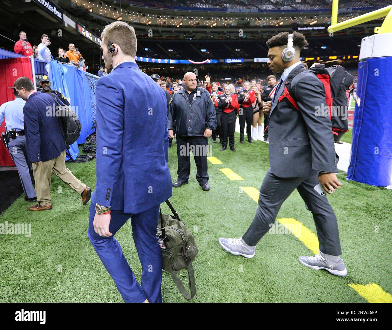 quarterbacks Jake Fromm, front, and Justin Fields arrive for