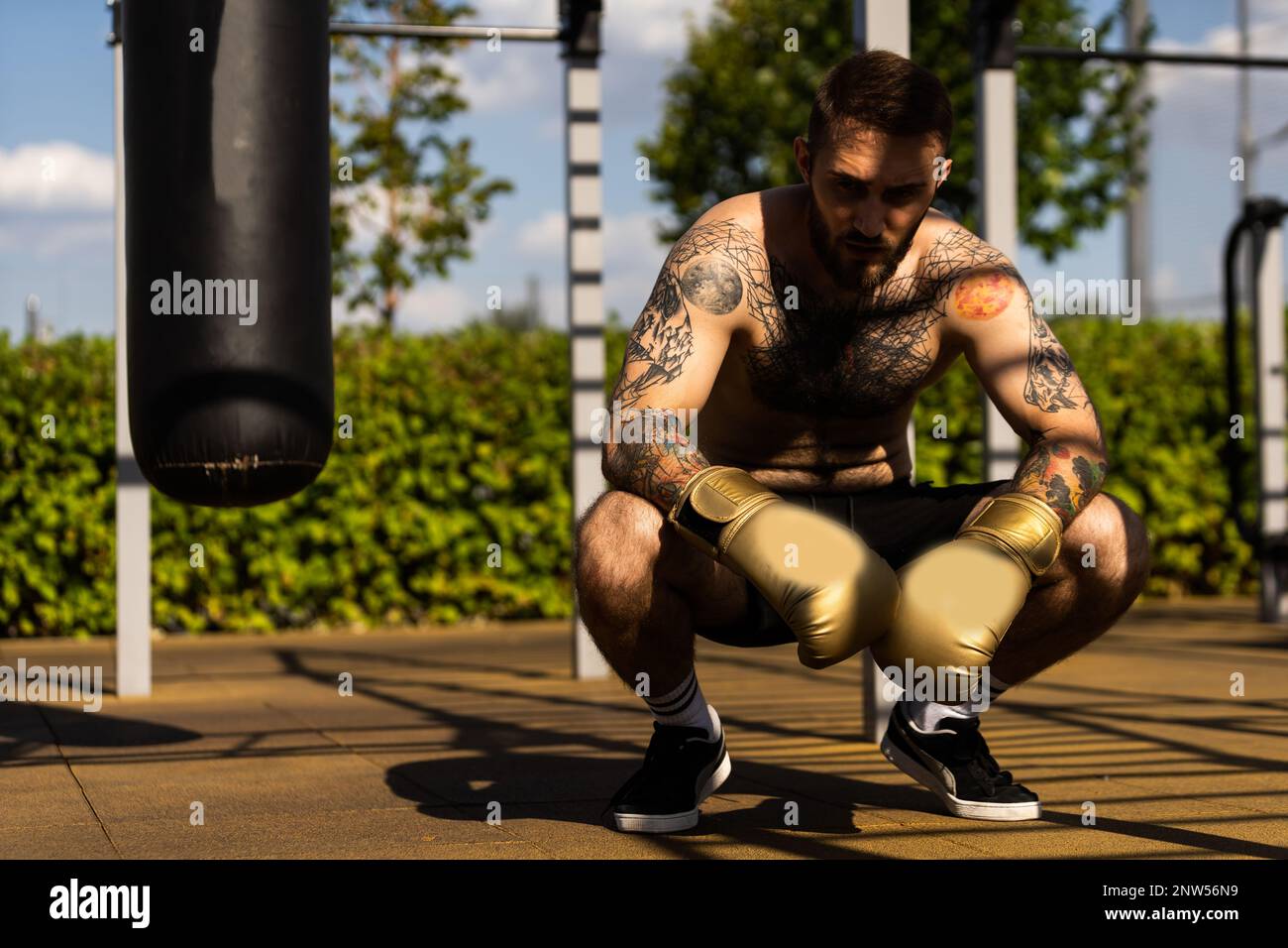 boxer athlete man putting on glove gloves prepared to train outdoors