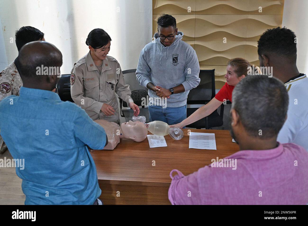 Army Lt. Col. Rhonda Dyre, Civil Affairs-Africa functional specialty team public health nurse, with medical members of the Japan Self-Defense Force and Spc. Reduan Hossain, Task Force Wolfhound medic, demonstrates CPR techniques to Djiboutian nurses during a knowledge exchange at the Djibouti Minister of Health complex in Djibouti City, Djibouti, Jan 30, 2023. The knowledge exchange educated Djiboutian nurses in basic life-saving techniques, CPR, maternal health, and infant care. Stock Photo