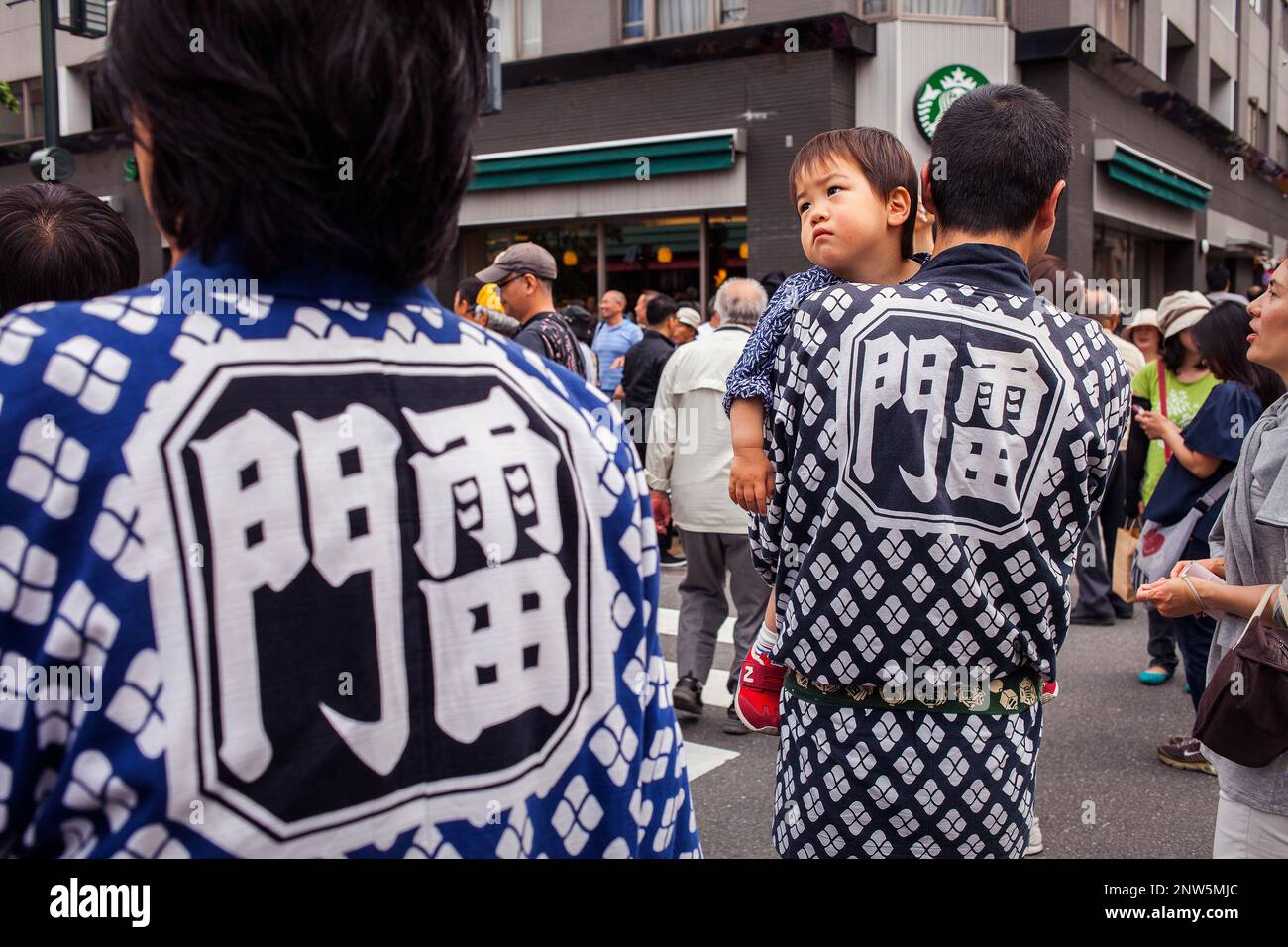 Bearers of Mikoshi and boy,during Sanja Matsuri Festival, in Kaminarimon dori,next to Sensoji Temple, Asakusa, Tokyo, Japan, Asia Stock Photo